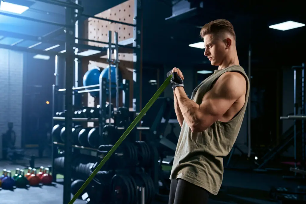 strength training for mass bodybuilder exercising with rubber
